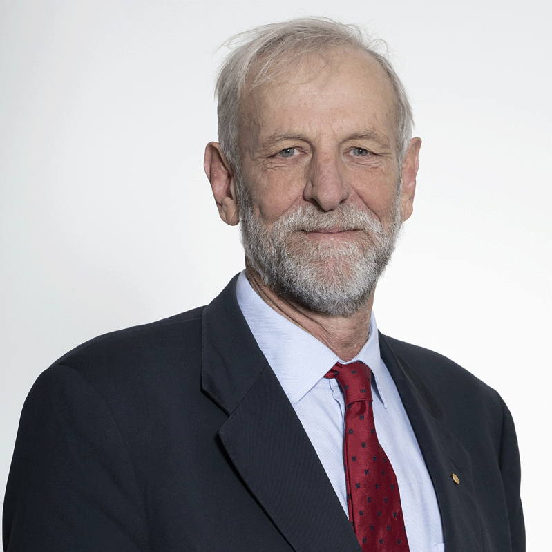 Headshot of Agriculture Committee Chair Hunter White, smiling and wearing a dark suit, light blue shirt, and red tie.