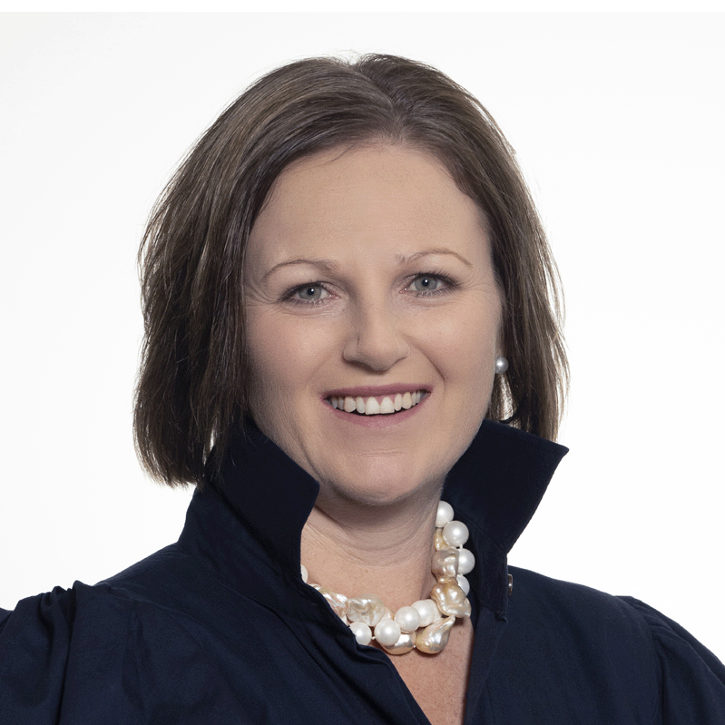 Headshot of Youth Affairs Committee Chair Susan Wakeford, wearing a navy blouse with a high collar and a pearl necklace.