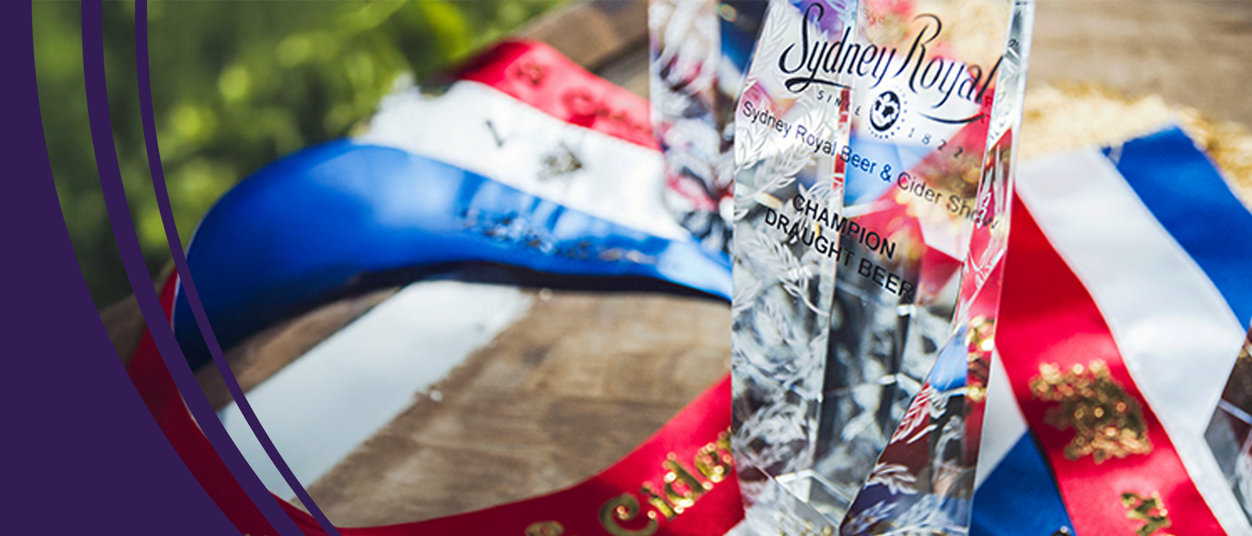 A glass Sydney Royal Beer & Cider Show trophy engraved with 