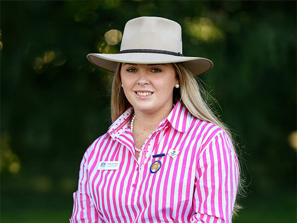 Headshot of 2025 finalist Phoebe Southwell, a woman in hat and striped shirt, smiling warmly.